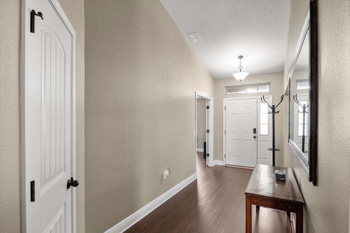 5755 Stream Mill Way Pace, FL 32571 - Photo 20 of 29 a view of a hallway with wooden floor