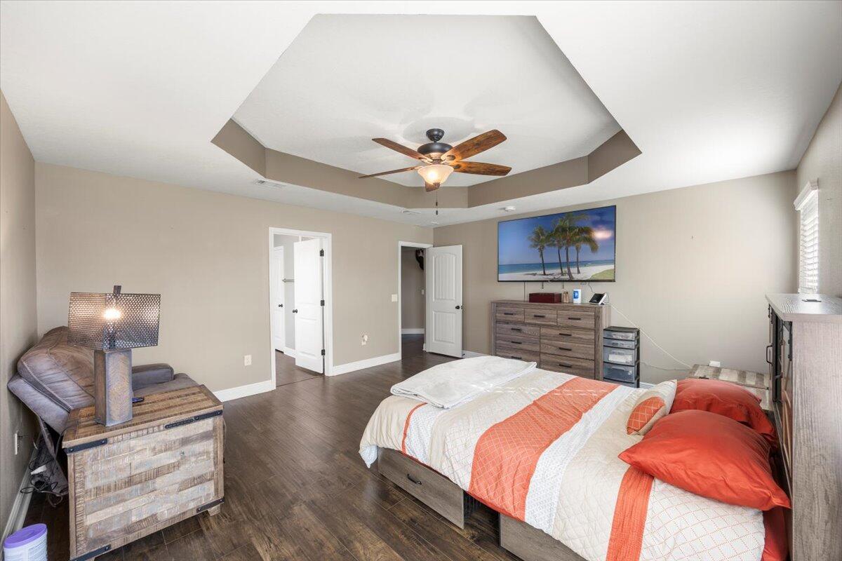 5755 Stream Mill Way Pace, FL 32571 - Photo 2 of 29 a bedroom with a bed and a chandelier