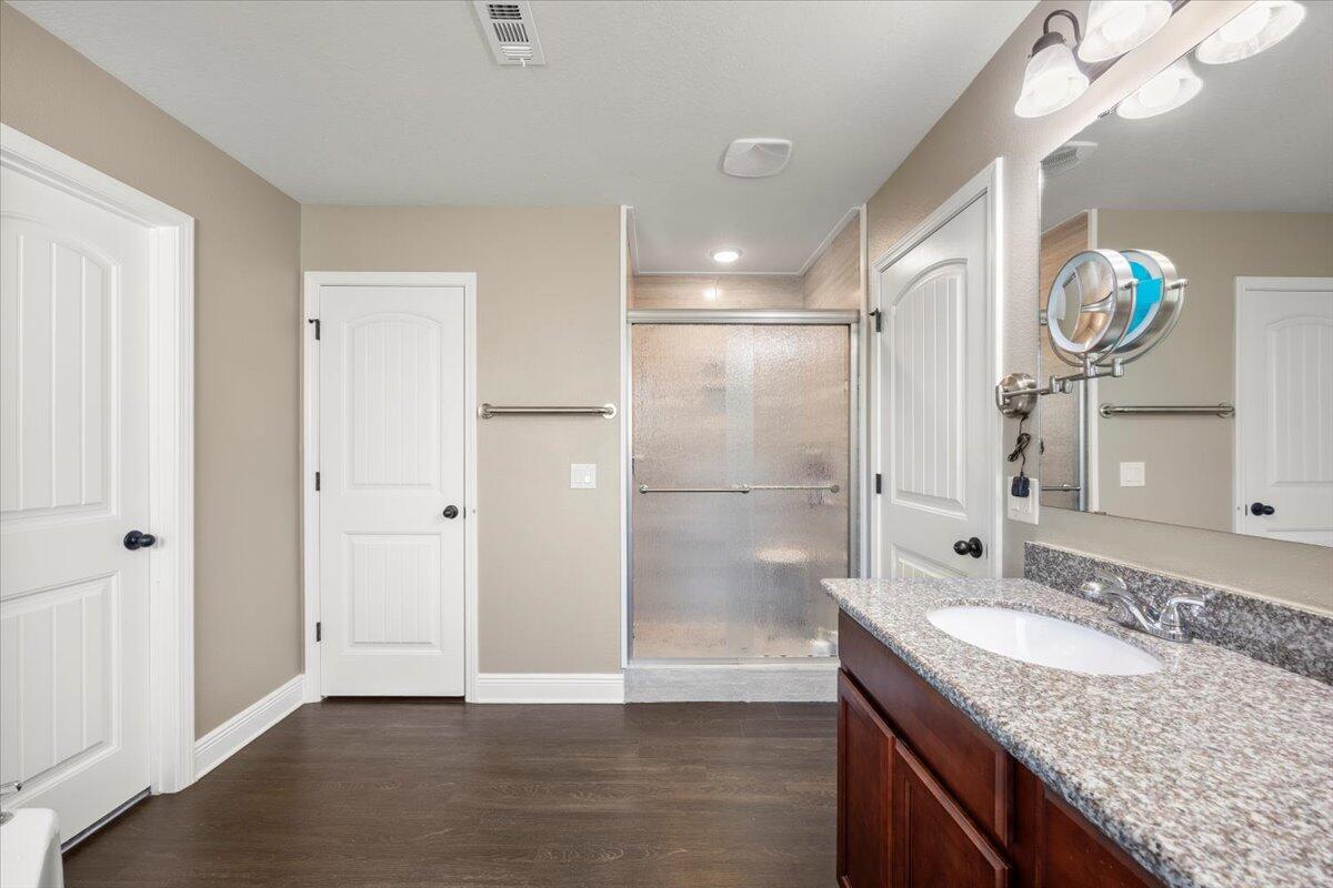 5755 Stream Mill Way Pace, FL 32571 - Photo 3 of 29 a bathroom with a granite countertop sink a mirror and a shower
