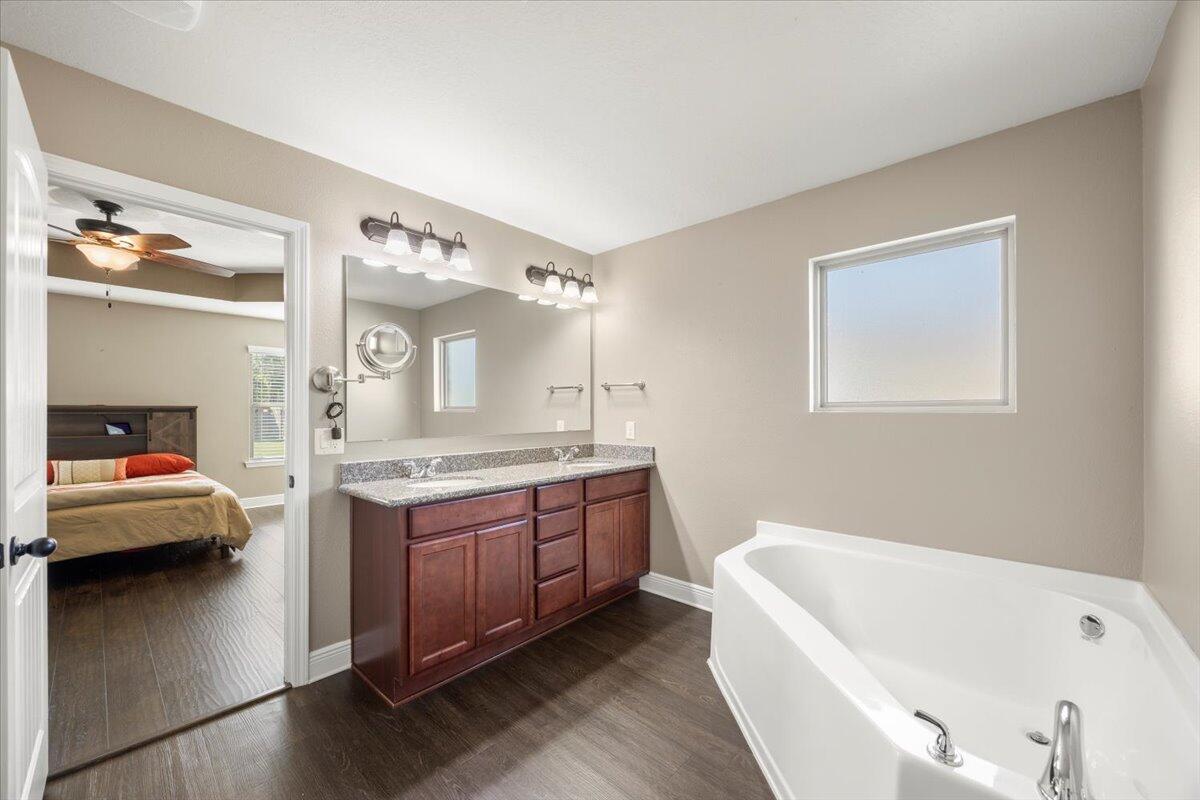 5755 Stream Mill Way Pace, FL 32571 - Photo 4 of 29 a bathroom with a tub sink and mirror