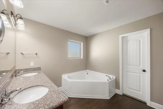 a bathroom with a granite countertop sink and mirror