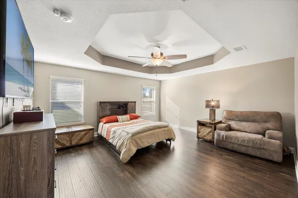 a bedroom with a bed and a couch