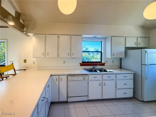 a kitchen with a sink cabinets and window