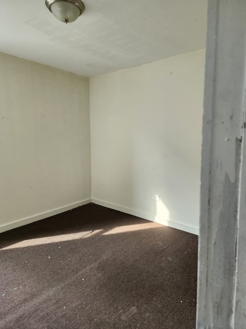 101 South Comstock Street, Unit 1 Joliet, IL 60436 - Photo 6 of 11 a view of an empty room and window
