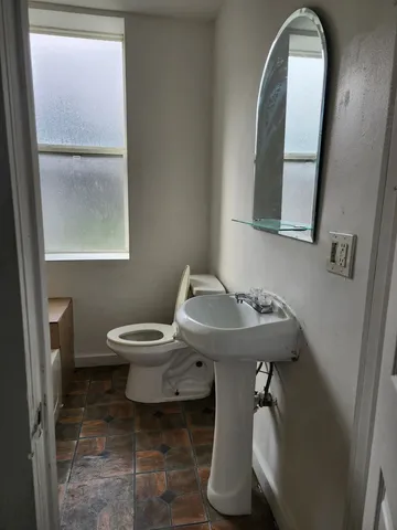 a view of a kitchen with a sink window and cabinets