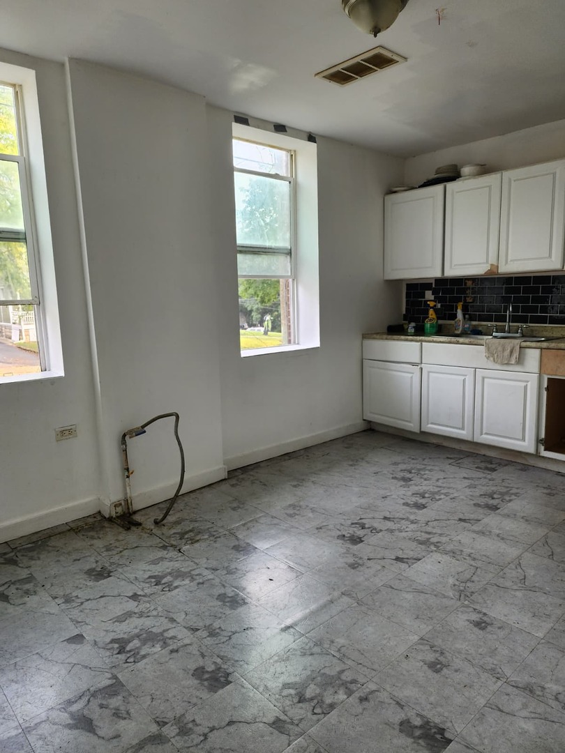 101 South Comstock Street, Unit 1 Joliet, IL 60436 - Photo 10 of 11 a view of a kitchen with a sink window and cabinets