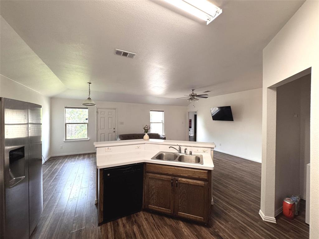 2831 Painted Trail Dallas, TX 75237 - Photo 3 of 14 a kitchen with a sink a stove a microwave and wooden floor