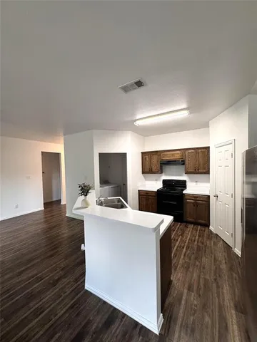 a living room with a couch and a wooden floor