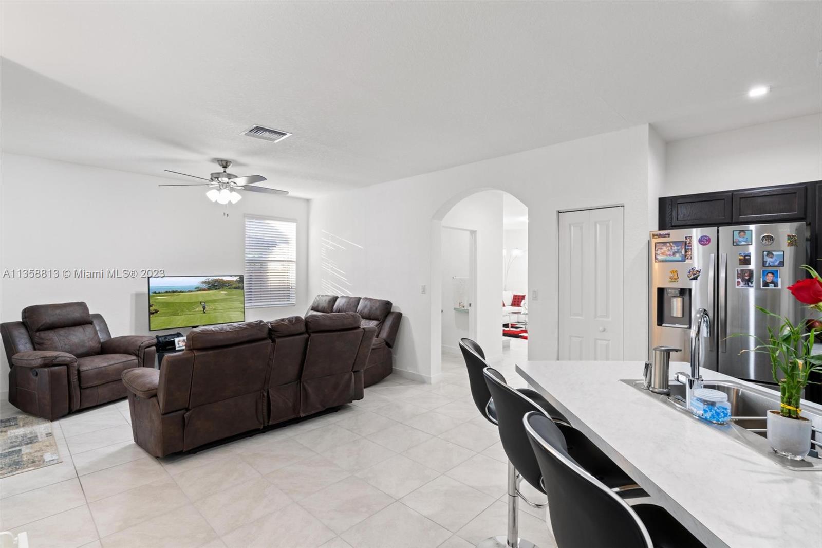 11744 Southwest 244 Street Homestead, FL 33032 - Photo 11 of 32 a living room with furniture and a chandelier