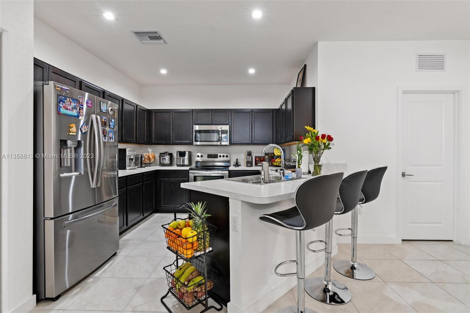 11744 Southwest 244 Street Homestead, FL 33032 - Photo 12 of 32 a kitchen with stainless steel appliances granite countertop a refrigerator and a stove top oven