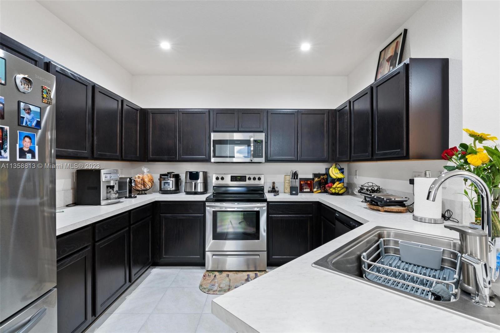 11744 Southwest 244 Street Homestead, FL 33032 - Photo 13 of 32 a kitchen with a sink a stove and cabinets