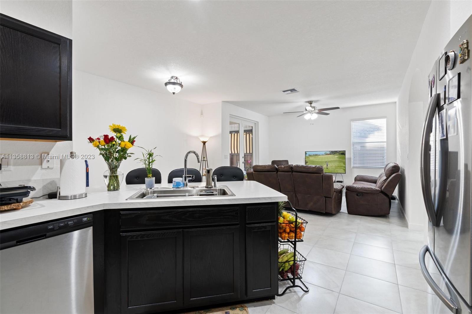 11744 Southwest 244 Street Homestead, FL 33032 - Photo 14 of 32 a kitchen with a sink dishwasher and a flat screen tv