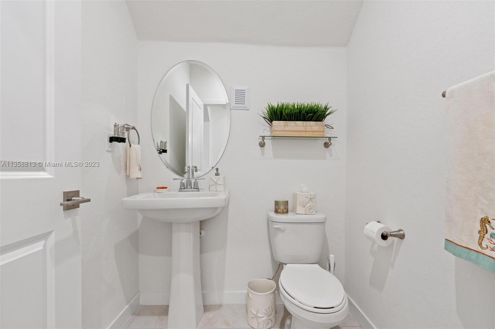 11744 Southwest 244 Street Homestead, FL 33032 - Photo 15 of 32 a bathroom with a sink a toilet and a mirror