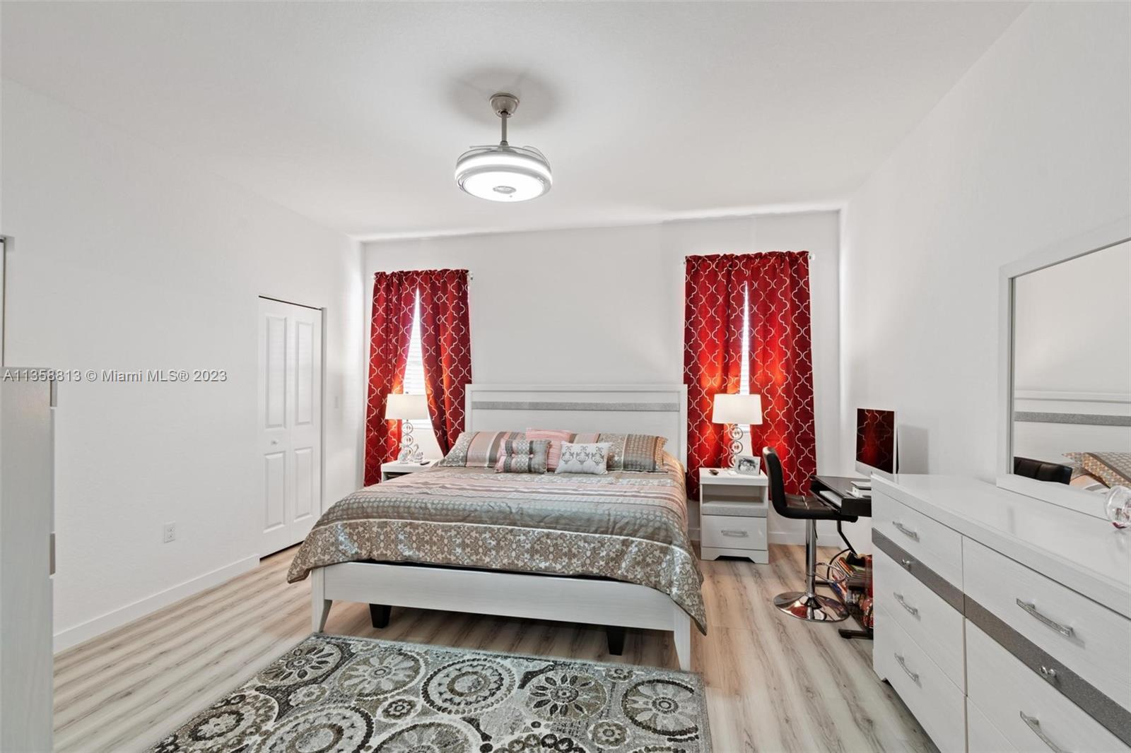 11744 Southwest 244 Street Homestead, FL 33032 - Photo 17 of 32 a bedroom with a bed and a flat screen tv