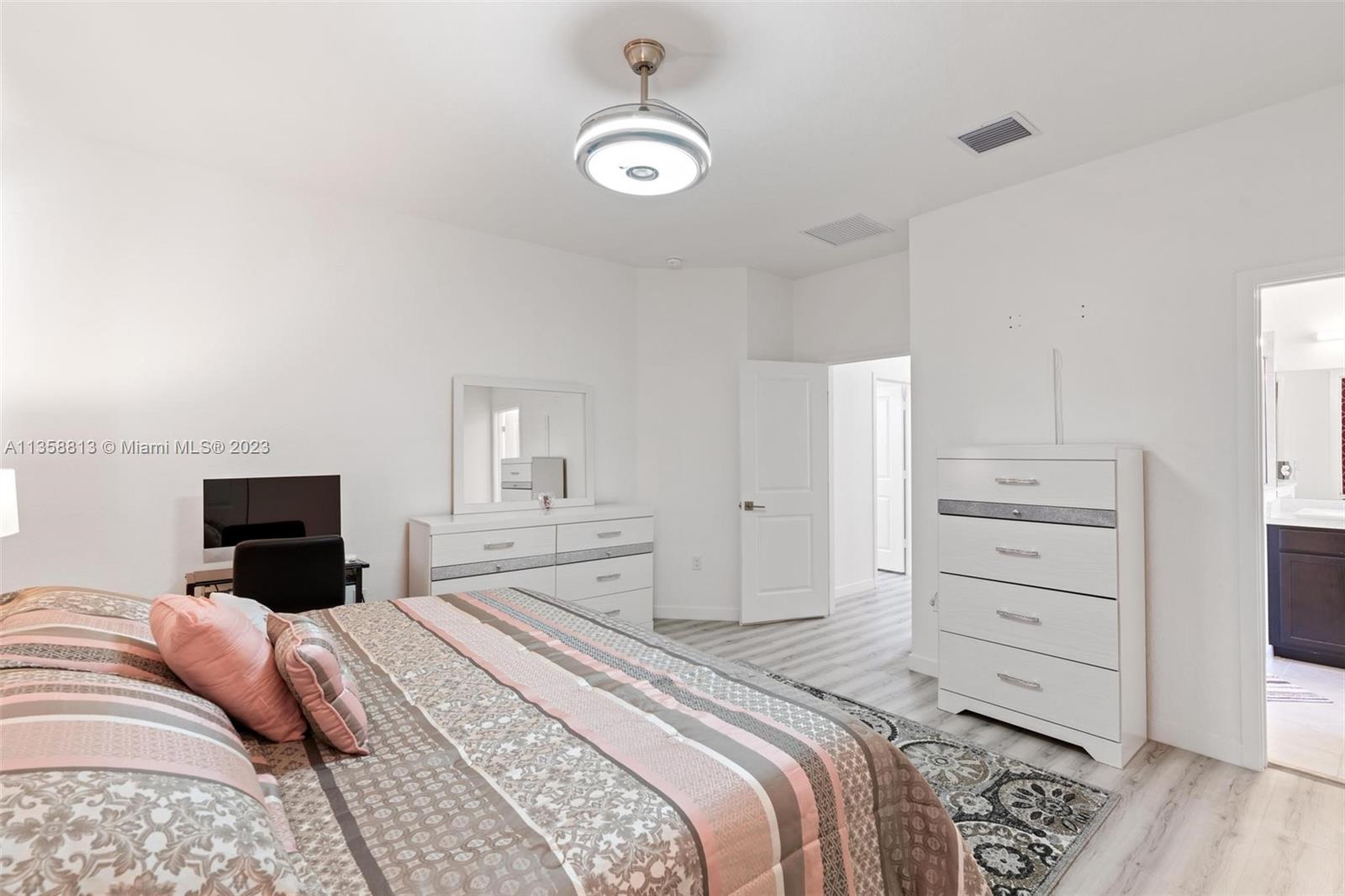 11744 Southwest 244 Street Homestead, FL 33032 - Photo 18 of 32 a bedroom with a bed and wooden floor