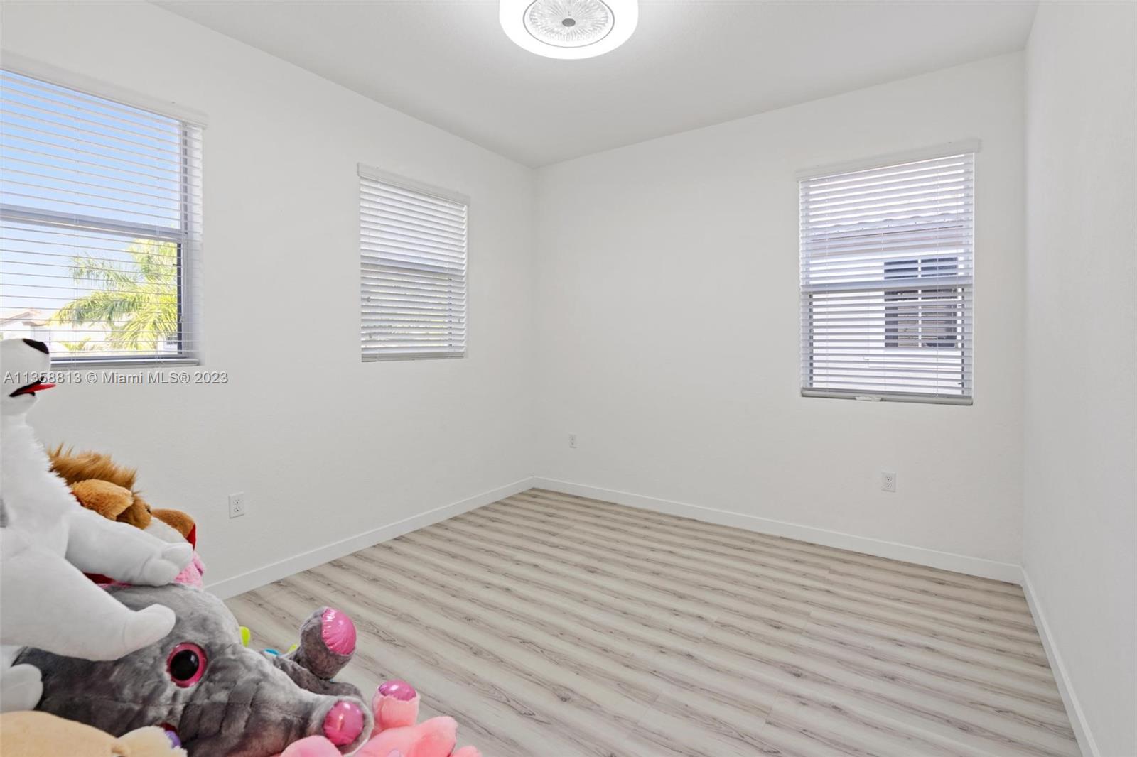 11744 Southwest 244 Street Homestead, FL 33032 - Photo 21 of 32 a room with wooden floor and a window