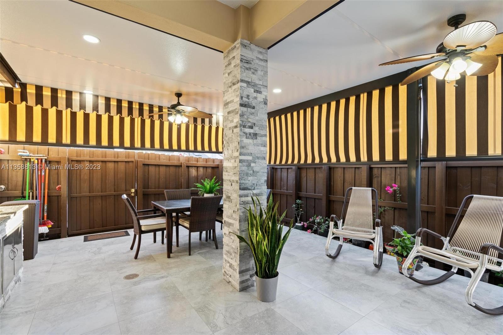 11744 Southwest 244 Street Homestead, FL 33032 - Photo 25 of 32 a dining room with furniture and a chandelier