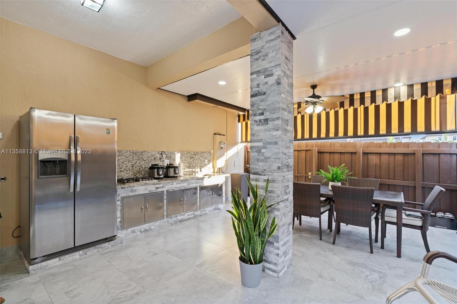11744 Southwest 244 Street Homestead, FL 33032 - Photo 26 of 32 a dining room with furniture and a potted plant