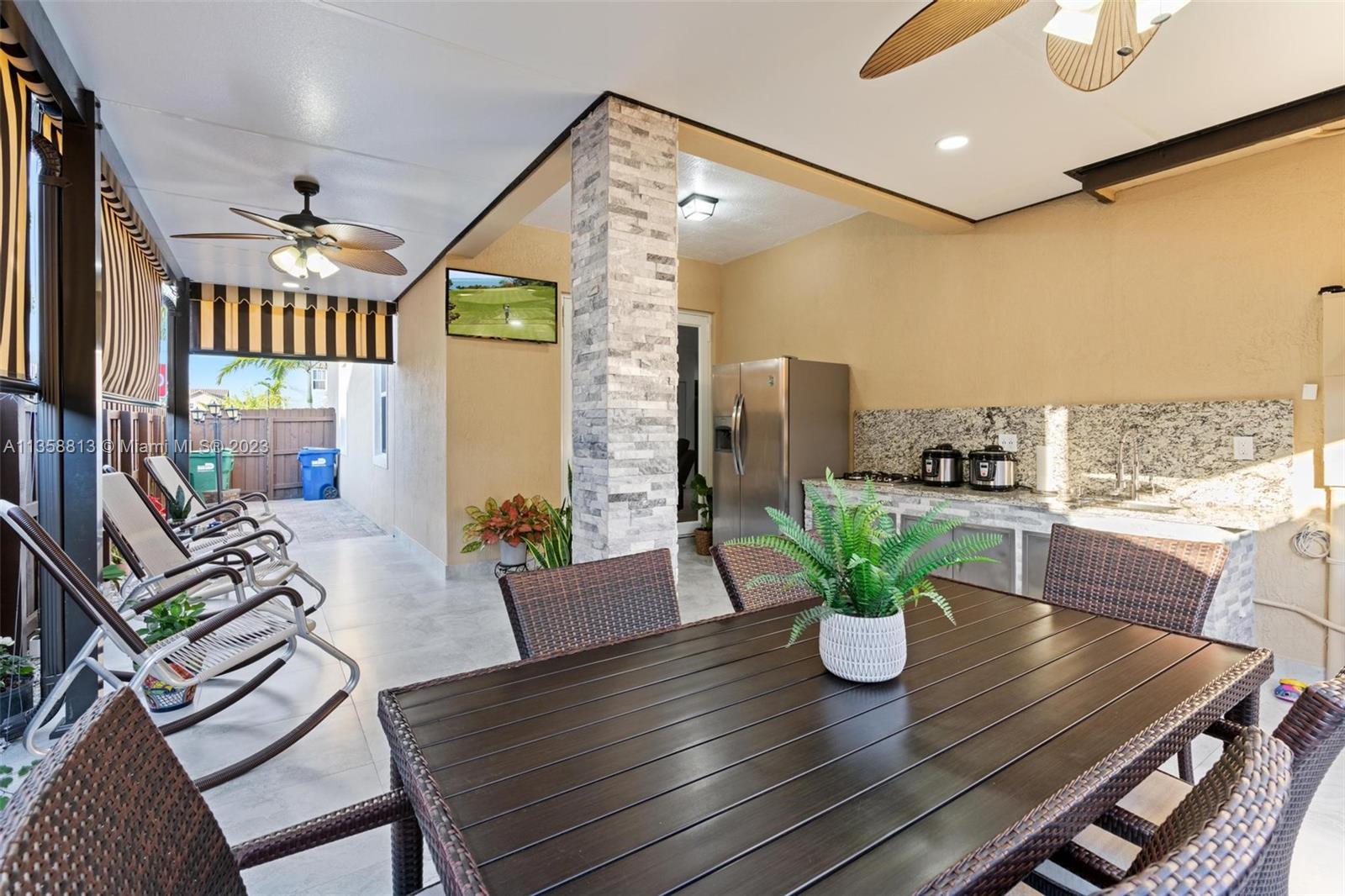 11744 Southwest 244 Street Homestead, FL 33032 - Photo 28 of 32 a dining room with furniture a potted plant and wooden floor