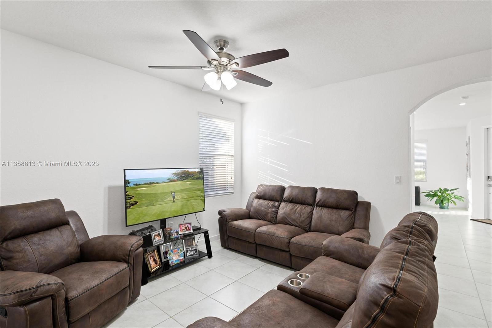 11744 Southwest 244 Street Homestead, FL 33032 - Photo 10 of 32 a living room with furniture and a flat screen tv