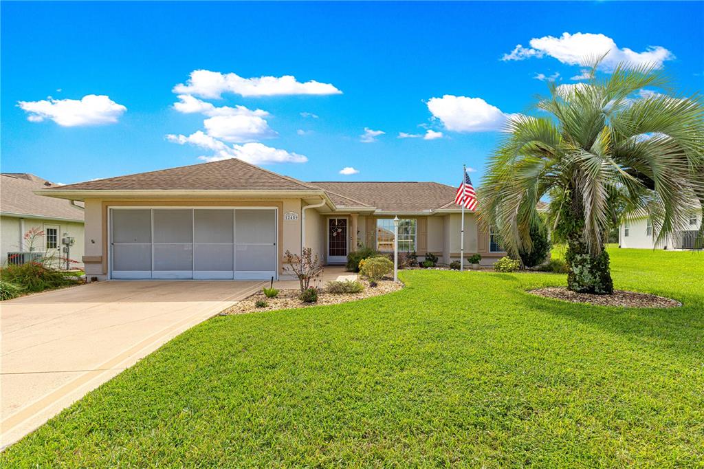 a front view of a house with patio and garden