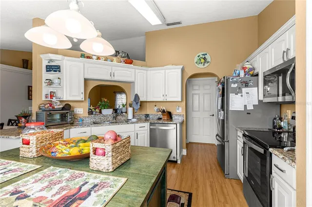 a living room with furniture a chandelier and a window