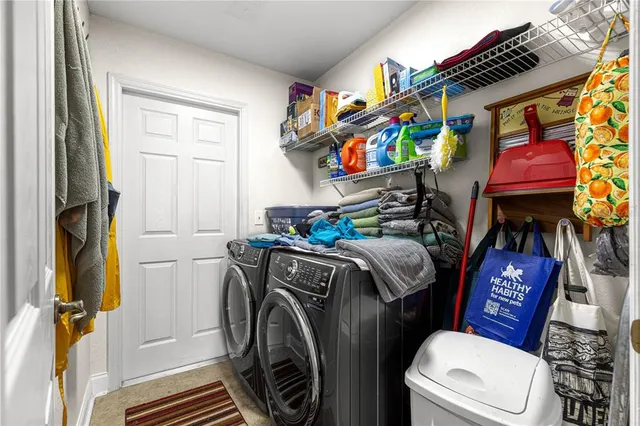 a view of a swimming pool with a lawn chairs and a fire pit