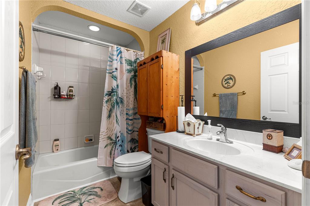 12459 Southeast 176th Loop Summerfield, FL 34491 - Photo 4 of 34 a bathroom with a bathtub shower sink vanity mirror and toilet