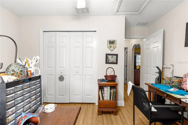 a kitchen with stainless steel appliances granite countertop a stove top oven a sink dishwasher and a dining table with wooden floor