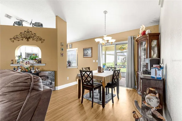 a kitchen with stainless steel appliances kitchen island granite countertop a stove refrigerator and cabinets
