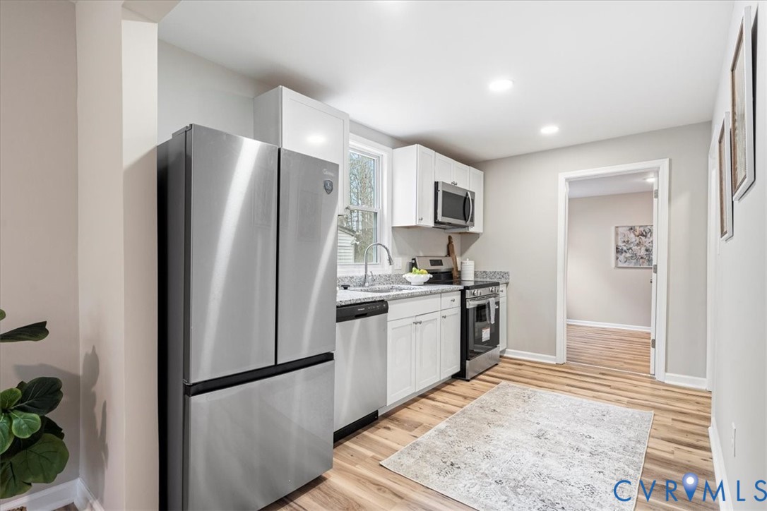 1989 Cox Road Blackstone, VA 23824 - Photo 12 of 44 a kitchen with stainless steel appliances granite countertop a refrigerator and a sink
