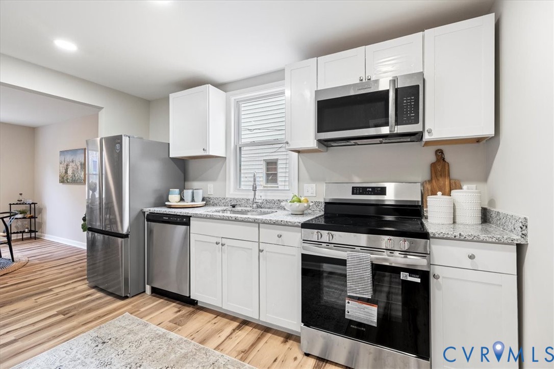 1989 Cox Road Blackstone, VA 23824 - Photo 14 of 44 a kitchen with stainless steel appliances granite countertop a stove microwave sink and refrigerator
