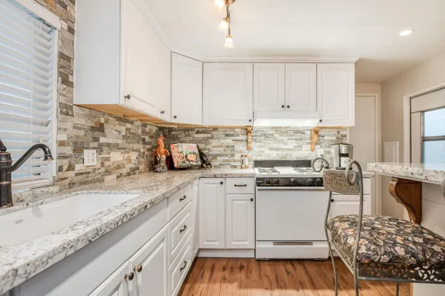 a view of a house with brick walls and flower plants