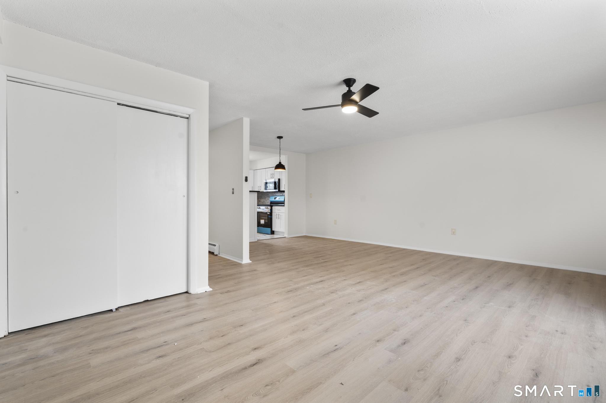 83 Sutton Place, Unit 83 Bloomfield, CT 06002 - Photo 12 of 29 a view of empty room with wooden floor