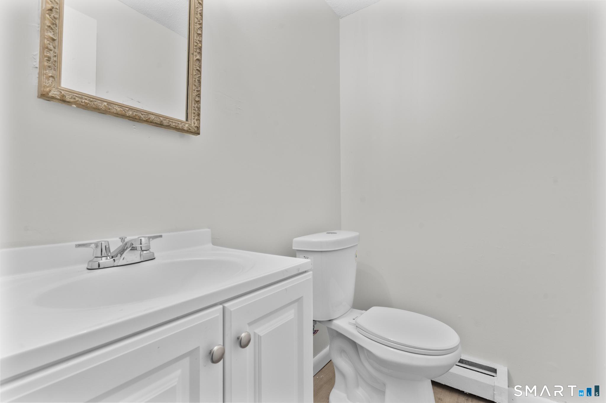 83 Sutton Place, Unit 83 Bloomfield, CT 06002 - Photo 14 of 29 a bathroom with a sink mirror and toilet