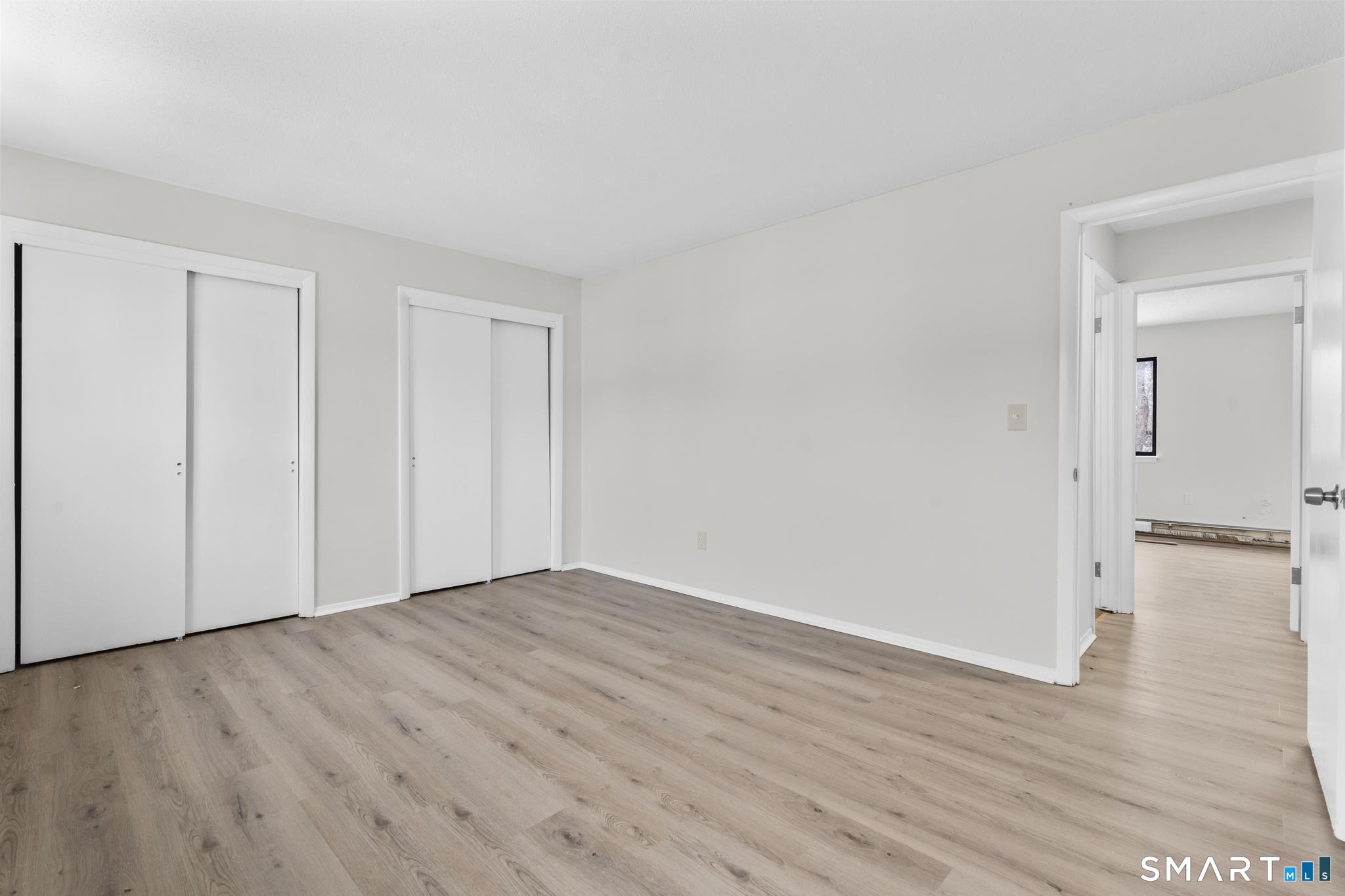 83 Sutton Place, Unit 83 Bloomfield, CT 06002 - Photo 16 of 29 a view of an empty room with wooden floor