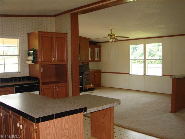 958 Langley Road Staley, NC 27355 - Photo 11 of 30 Kitchen with island open to the den and dining room.