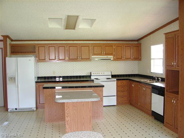 958 Langley Road Staley, NC 27355 - Photo 13 of 30 Kitchen with all the appliances including washer & dryer.