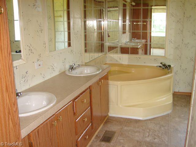 958 Langley Road Staley, NC 27355 - Photo 25 of 30 Master Bath with double sinks and garden tub with separate shower.