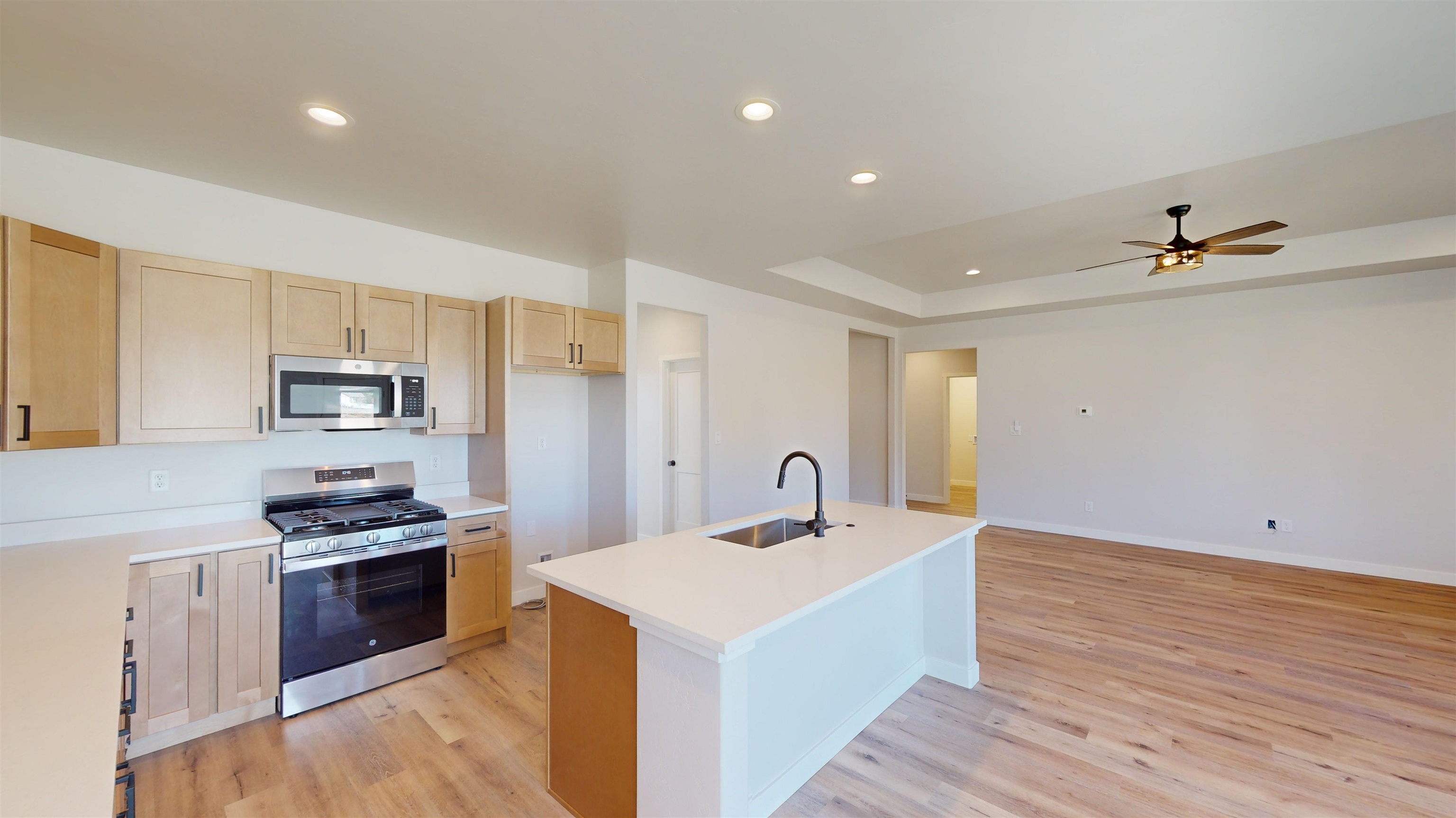 2954 Apollo Drive Grand Junction, CO 81504 - Photo 11 of 40 a kitchen with a refrigerator and a stove top oven