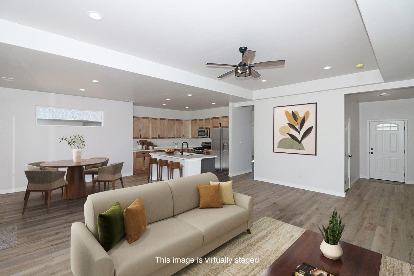2954 Apollo Drive Grand Junction, CO 81504 - Photo 18 of 40 a living room with furniture kitchen view and a potted plant
