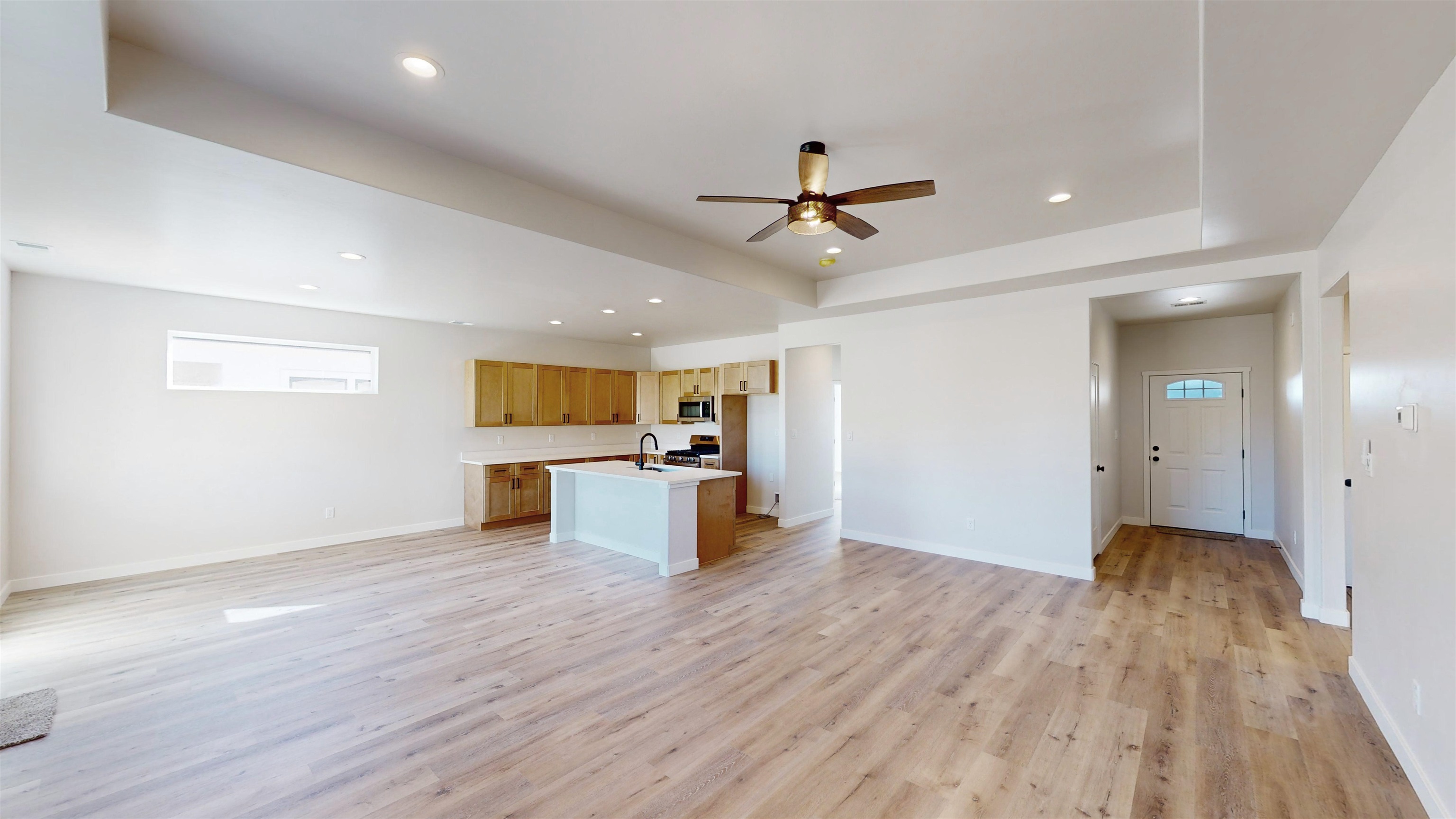 2954 Apollo Drive Grand Junction, CO 81504 - Photo 19 of 40 a view of a kitchen with wooden floor and a ceiling fan