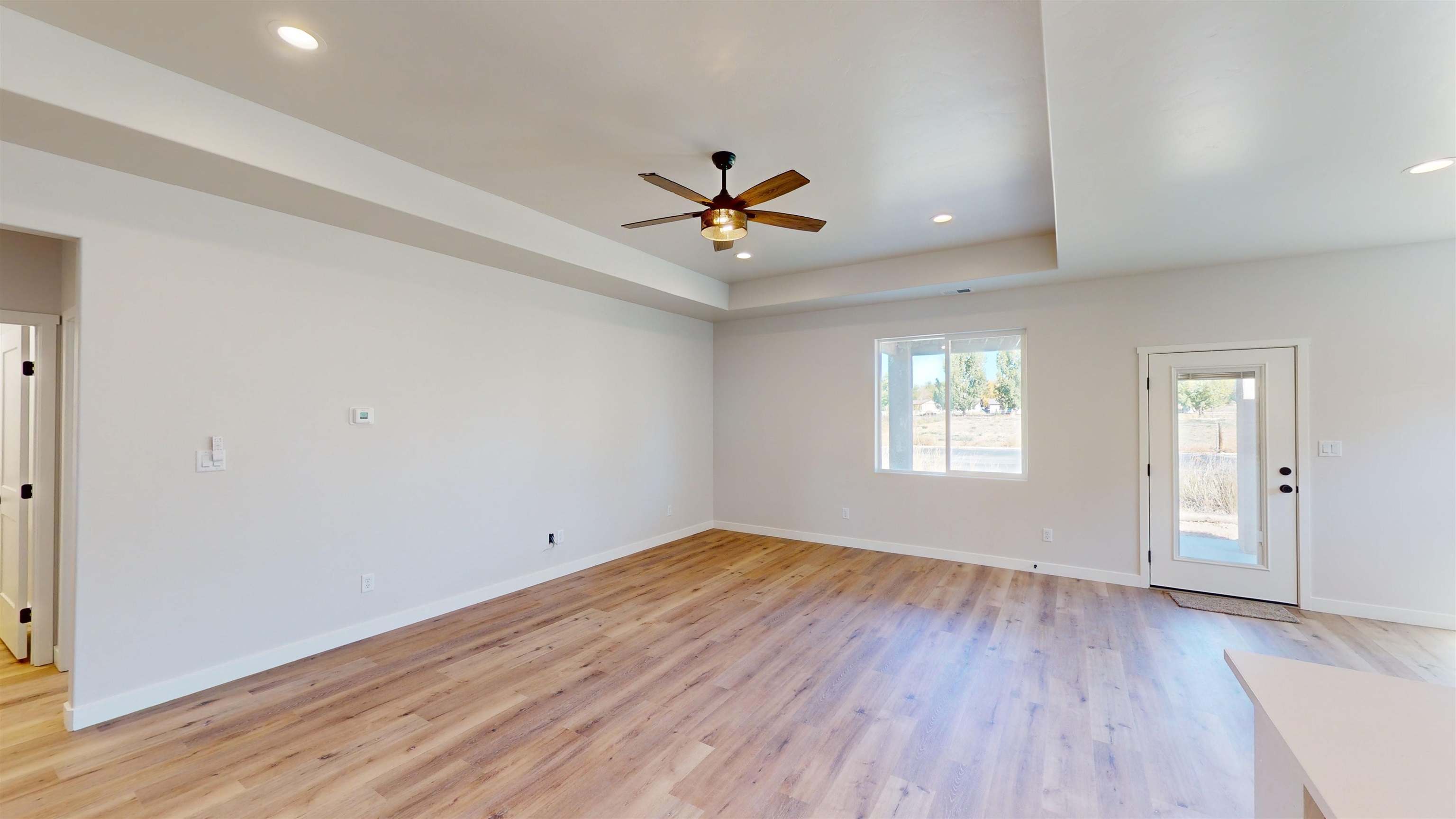 2954 Apollo Drive Grand Junction, CO 81504 - Photo 20 of 40 an empty room with wooden floor and windows