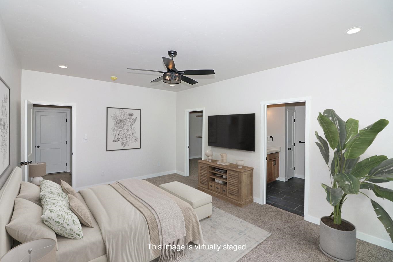 2954 Apollo Drive Grand Junction, CO 81504 - Photo 25 of 40 a bedroom with a bed and a flat screen tv