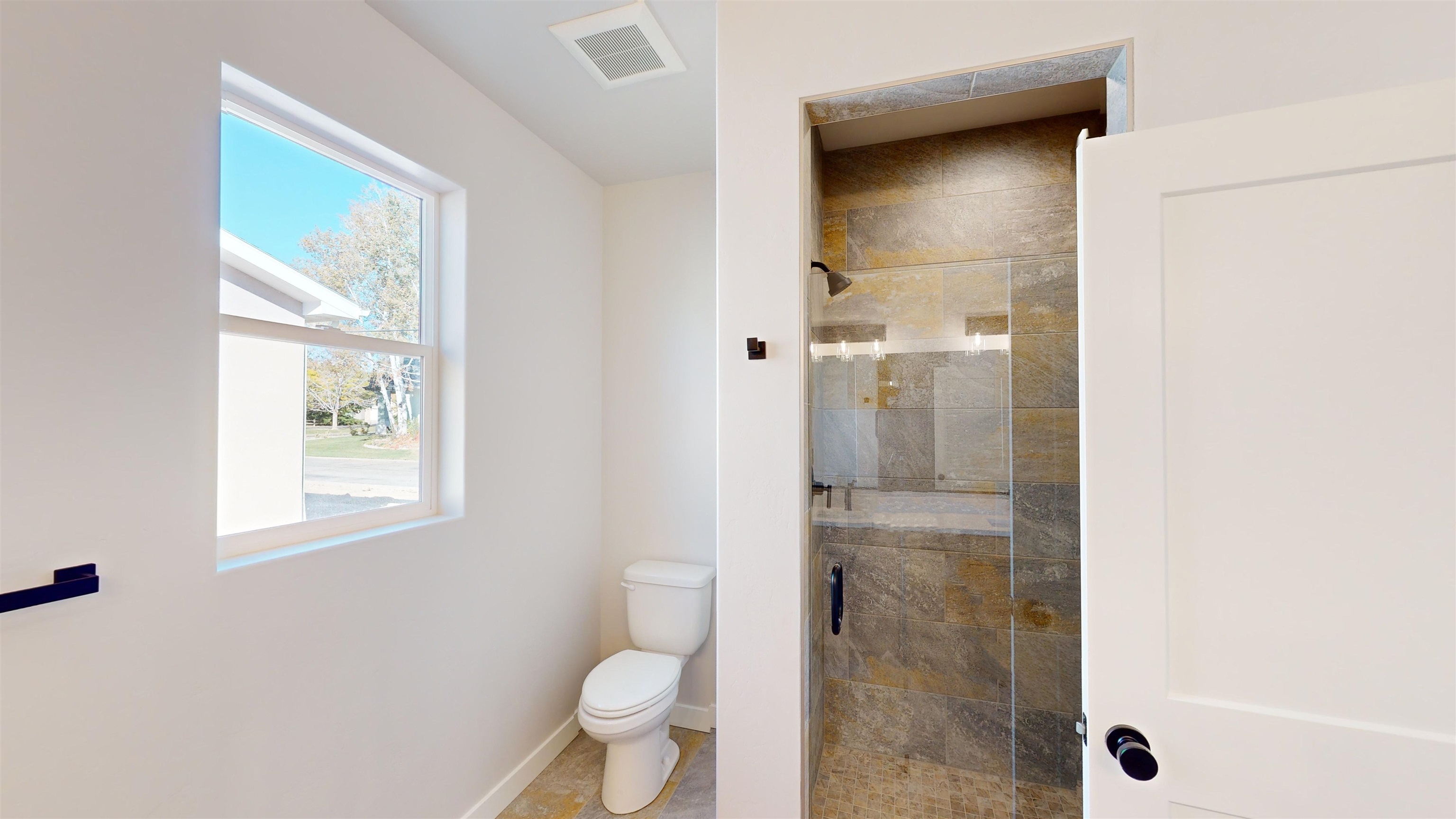 2954 Apollo Drive Grand Junction, CO 81504 - Photo 31 of 40 a bathroom with a granite countertop shower a toilet and a sink