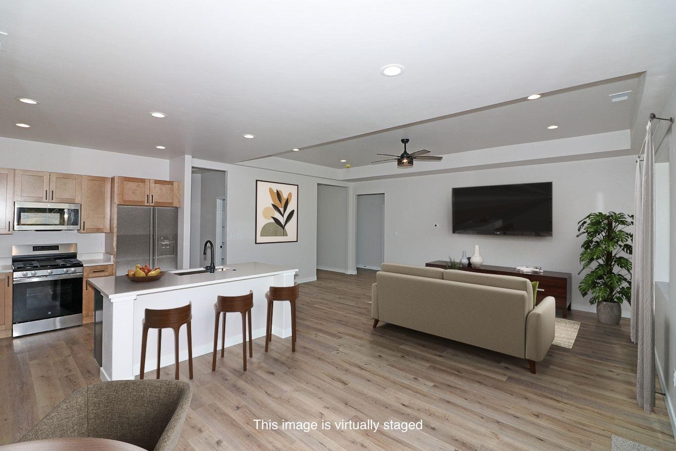 2954 Apollo Drive Grand Junction, CO 81504 - Photo 8 of 40 a living room with furniture and a flat screen tv