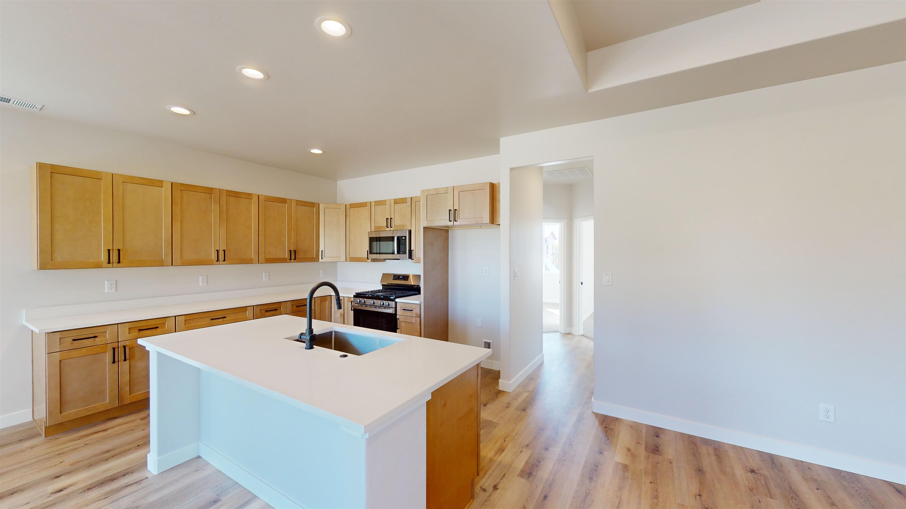 2954 Apollo Drive Grand Junction, CO 81504 - Photo 10 of 40 a kitchen with a sink a refrigerator and wooden floor