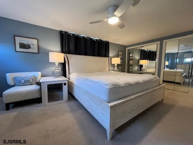 a bedroom with a large bed and a couch