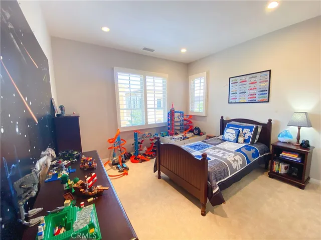 a bed room with furniture and a flat screen tv