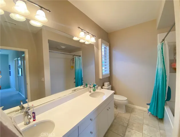 a bathroom with a double vanity sink and mirror